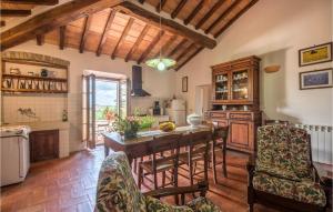 a large kitchen with a wooden table and chairs at Beautiful Home In San Quirico Dorcia With Kitchen in San Quirico dʼOrcia