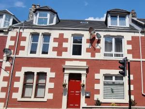 a house with a cross on the side of it at Largs Apartment, Spacious & Modern 1 Bed near beach & shops in Largs