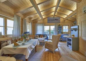 a living room with a table and chairs in a room at Chalet Bergheimat in Wegscheid