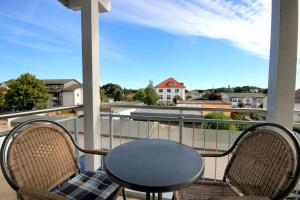 a table and chairs on a balcony with a view at Villa Karina by Rujana in Göhren