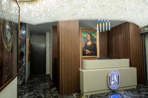 a lobby of a hotel with a portrait of a woman at MONALİSA HOTELS in Kusadası