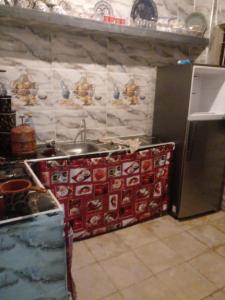 eine Küche mit einer Theke mit einer Spüle und einem Kühlschrank in der Unterkunft Wad fes hay Molay Driss GH14 in Fès