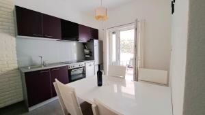 a kitchen with purple cabinets and a white counter top at Center Apartment with Terrace and Free Parking in Kaštela