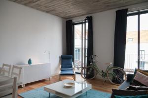 a living room with a bike on the wall at FLH Intendente Relaxing Apartment in Lisbon