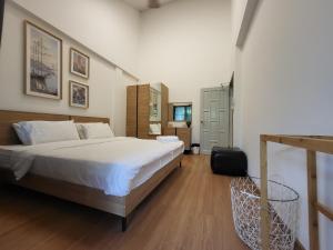 a bedroom with a large white bed and a chair at Nimman home 4 bedroom near One Nimman in Chiang Mai