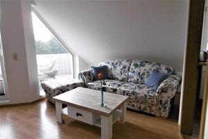 a living room with a couch and a table at Ruegen Fewo 70 in Dreschvitz