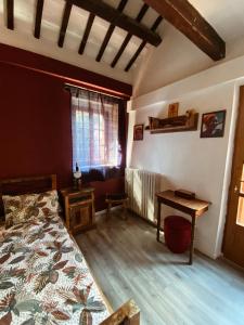 a bedroom with a bed and a desk and a window at Casal Camillo in Case Selva Grande
