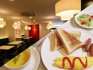 a plate of food on a counter with breakfast foods at Palude Kushiro in Kushiro