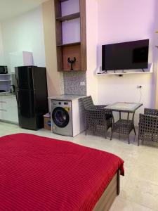 a living room with a washing machine and a table at Jasmine Resort & Aqua park in Sharm El Sheikh