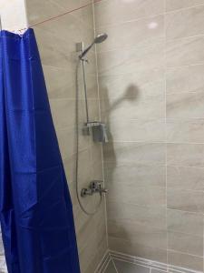 a shower with a blue shower curtain in a bathroom at Jasmine Resort & Aqua park in Sharm El Sheikh