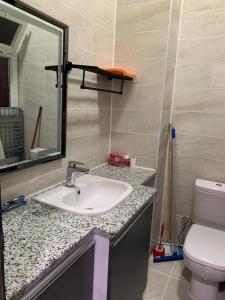 a bathroom with a sink and a toilet and a mirror at Jasmine Resort & Aqua park in Sharm El Sheikh