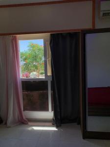 a room with a window with a black curtain at Jasmine Resort & Aqua park in Sharm El Sheikh