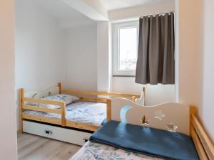 a bedroom with two bunk beds and a window at Amoroso apartment 200m from sea in Poreč