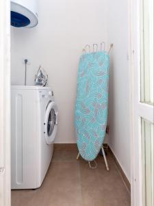 a laundry room with a washer and a washing machine at Amoroso apartment 200m from sea in Poreč