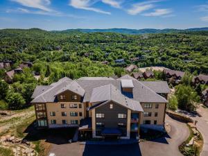 an aerial view of a large house with at Horizon 1-203 / Warm and cozy condo with a view! in Mont-Tremblant