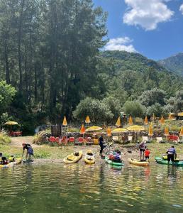 a group of people in kayaks on a river at Köyceğiz Sultaniye Camping in Mugla