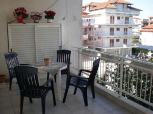 a table and chairs on a balcony with a view at Paralia Apartments in Paralia Katerinis