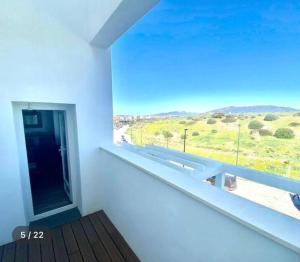 a room with a window with a view of a field at Sunset view * Swimming pool* A/C in Tarifa