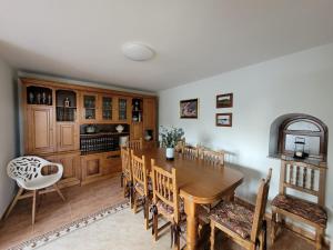 a dining room with a wooden table and chairs at La Tablada in Recuevo