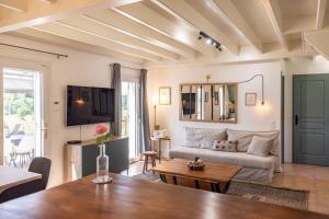 a living room with a couch and a table at Domaine du Pré de l'étang in Montazeau