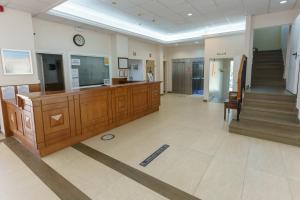 a lobby with a staircase and a clock on the wall at Checkin Catalonia in Calella