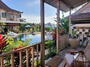 a view of a pool from the balcony of a house at Spaces Bali Unique Boutique Hotel in Munggu