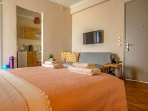 a bedroom with a bed with towels on it at Frida appartment in Preveza