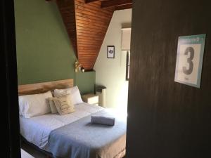 a bedroom with a bed with a suitcase on it at Casa Verde 3 in Godoy Cruz +7 photos