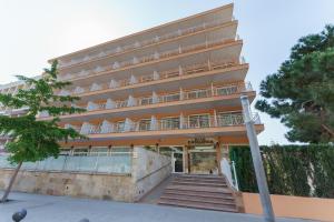 a large building with stairs in front of it at Checkin Catalonia in Calella