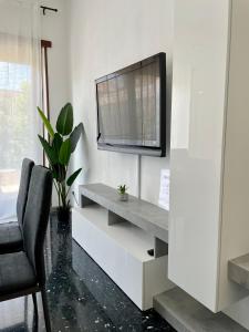 a living room with a television and a chair at A Due Passi dal Castello - Appartamento con Vista in Bracciano