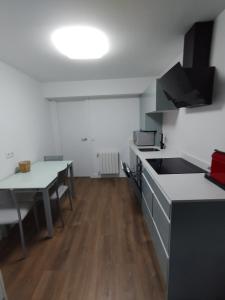 a kitchen with a table and a counter top at Rincón Gótico in Burgos +7 photos