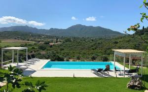 a swimming pool with a view of a mountain at La Casa di Alice Turchese in Olbia