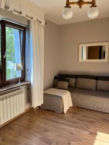 een slaapkamer met een bed en een raam bij Apartamenty Villa 28 in Pobierowo