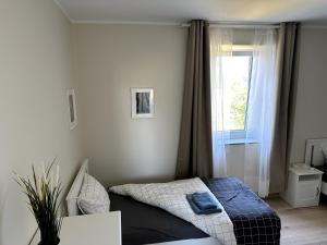 a small bedroom with a bed and a window at Deluxe Double Rooms Helfant Luxembourg 