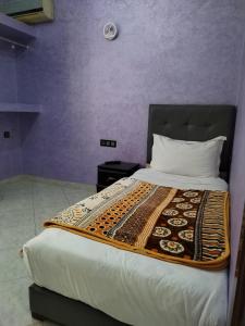 Postel nebo postele na pokoji v ubytování Riad Rayan's Guests