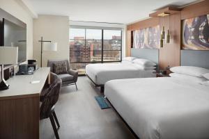 a hotel room with two beds and a desk at Marriott Knoxville Downtown in Knoxville +72 photos