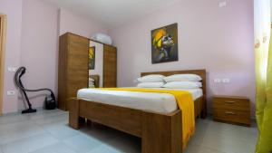 a bedroom with a bed with white sheets and pillows at Miloen Residence Gjiri I Lalzit in Durrës