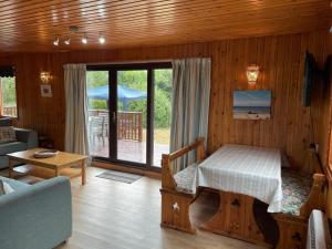 a living room with a bed and a room with a porch at The Vital Spark in Gatehouse of Fleet