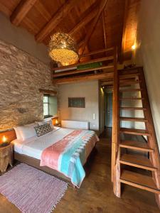 a bedroom with a large bed and a staircase at Pritanio in Polídhroson