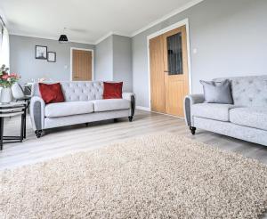 a living room with two couches and a rug at Campbeltown View in Campbeltown