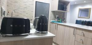 a kitchen with two appliances sitting on a counter at Rietvlei at Margate Boulevard in Margate