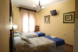 Ein Bett oder Betten in einem Zimmer der Unterkunft Hostal Rocio