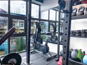 a gym with tread machines and a window at Pacific Hotel in Phnom Penh