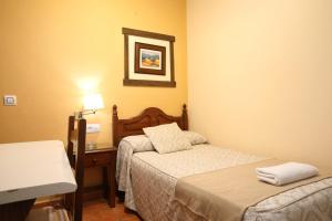 Ein Bett oder Betten in einem Zimmer der Unterkunft Hostal Rocio
