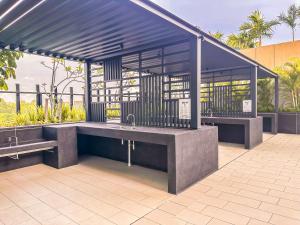 a pavilion with two benches in a building at StaySuites The Apple Melaka in Melaka