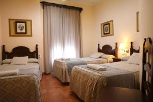 Ein Bett oder Betten in einem Zimmer der Unterkunft Hostal Rocio