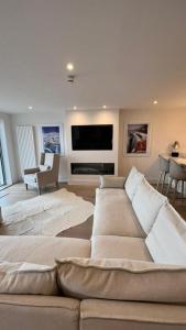 a living room with a couch and a flat screen tv at Morelli Plaza Portstewart in Portstewart