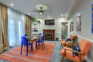 a dining room with a table and blue chairs at Charming Downtown Retreat Steps from Capitol Bldg in Harrisburg