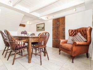 a dining room with a table and chairs at The Barn at Trevothen Farm in Helston