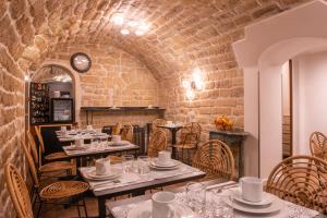 a restaurant with tables and chairs and a clock at Hôtel Istria by Magna Arbor in Paris +19 photos